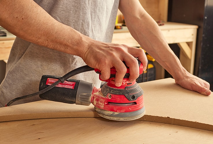 Person sanding an MDF board