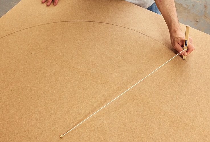 Person tracing the curve of an arch design