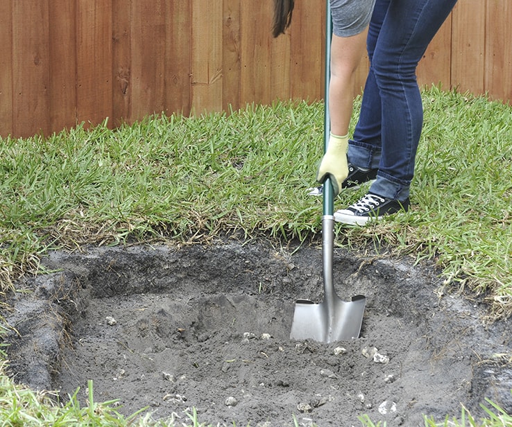 Woman digging a hole in the ground