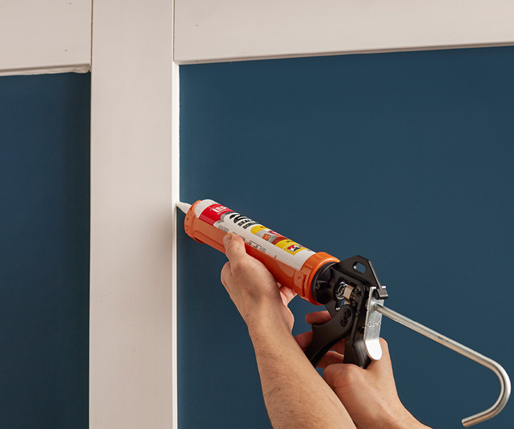 Person using a caulking gun