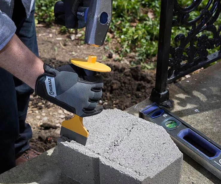 Person removing flanges from retaining blocks