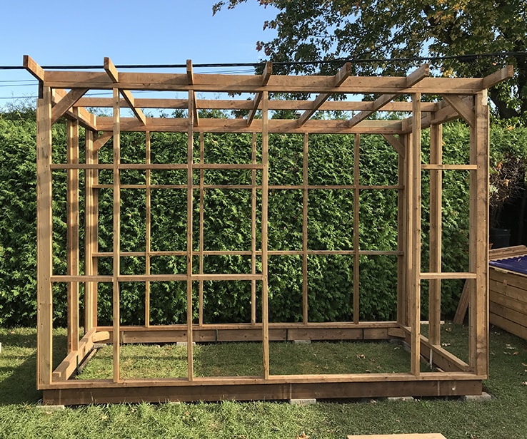 Wooden greenhouse with a pergola-style roof