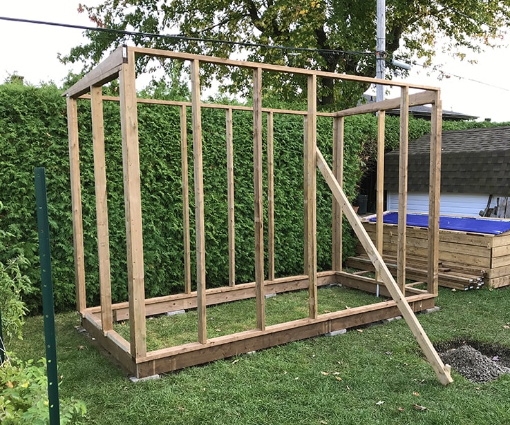 Structure of a wooden backyard greenhouse