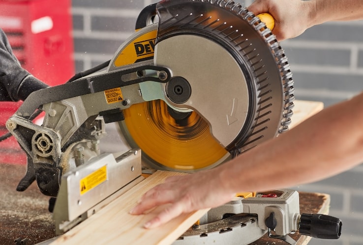 Person using a mitre saw