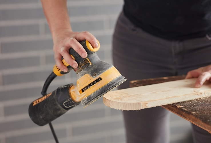 Person using an orbital sander