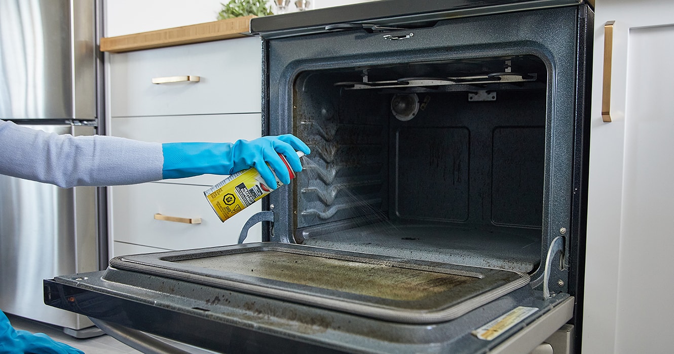 Person cleaning an oven door