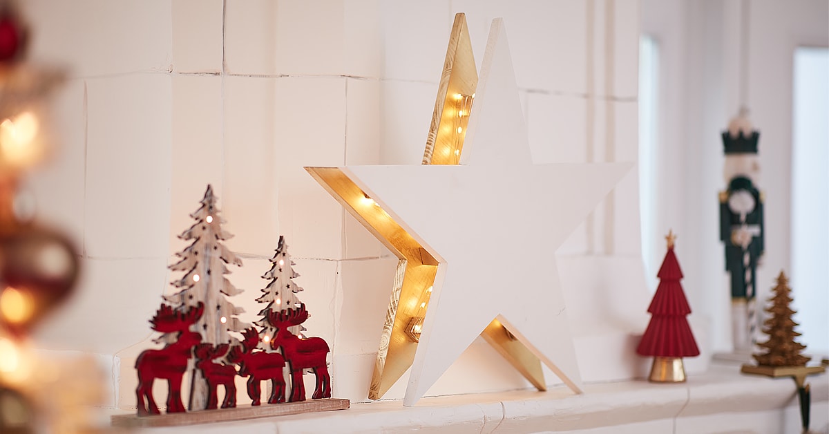 Wooden double star with lights on a shelf