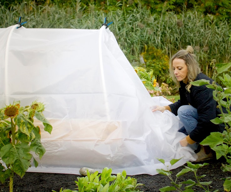 Woman closing a grow tunnel