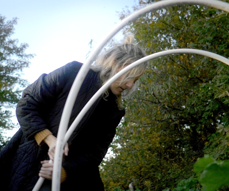 Woman creating an arch with a pipe