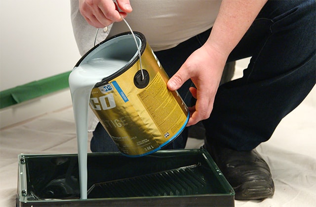 Man pouring paint into a pan