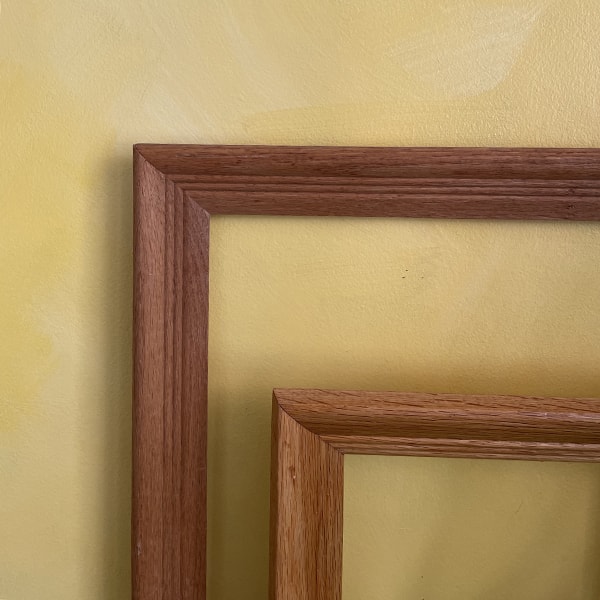 Wooden frames in front of a yellow accent wall