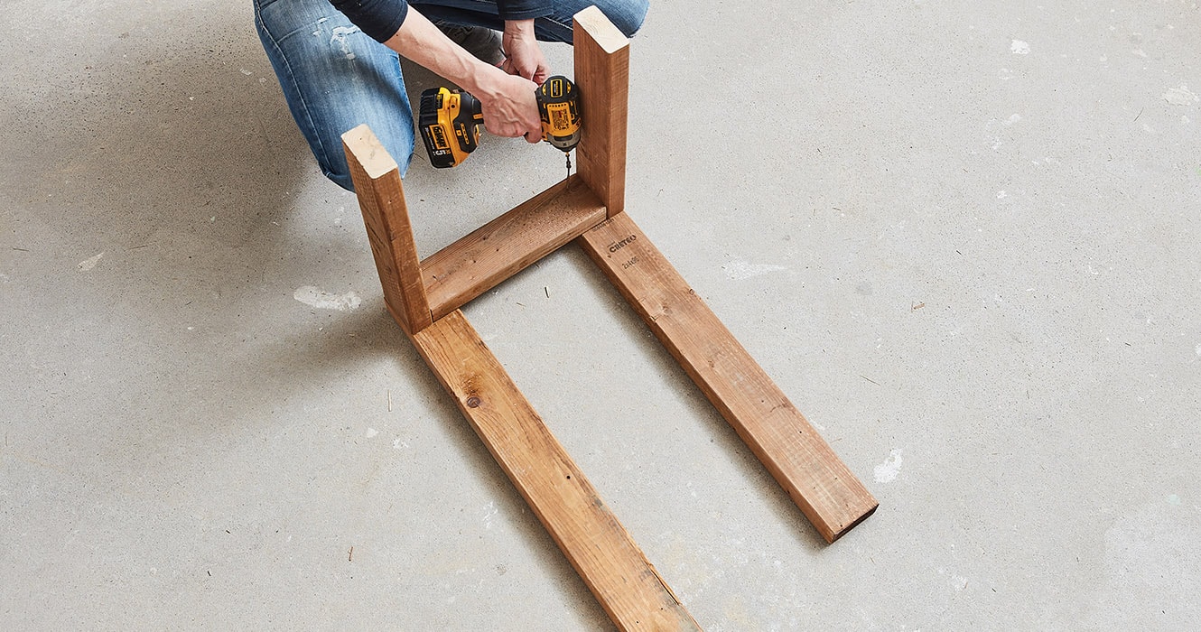 Women assembling a wooden structure