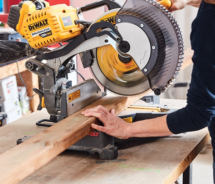 Woman using a mitre saw