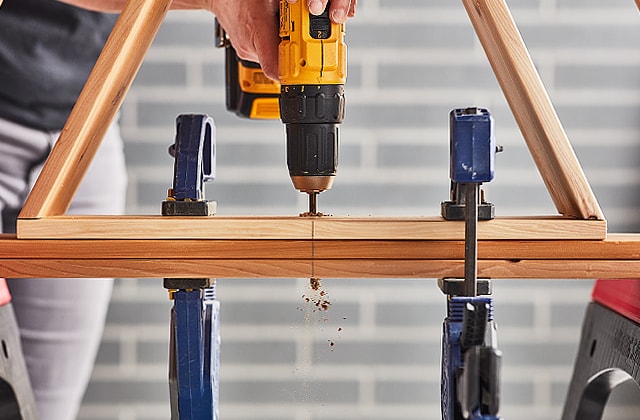 Person drilling a hole with a drill