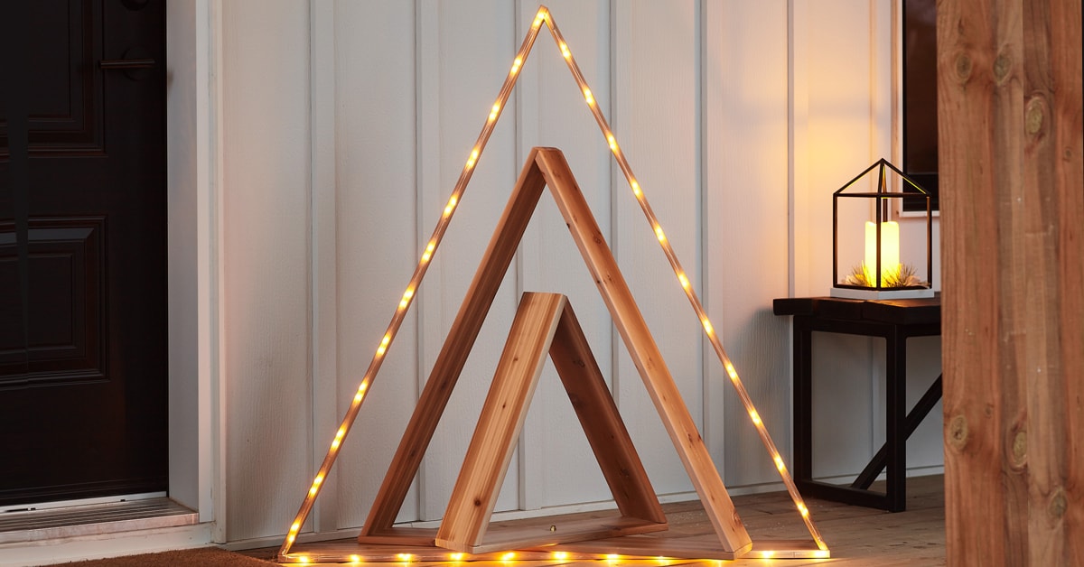 Illuminated cedar Christmas tree on a porch