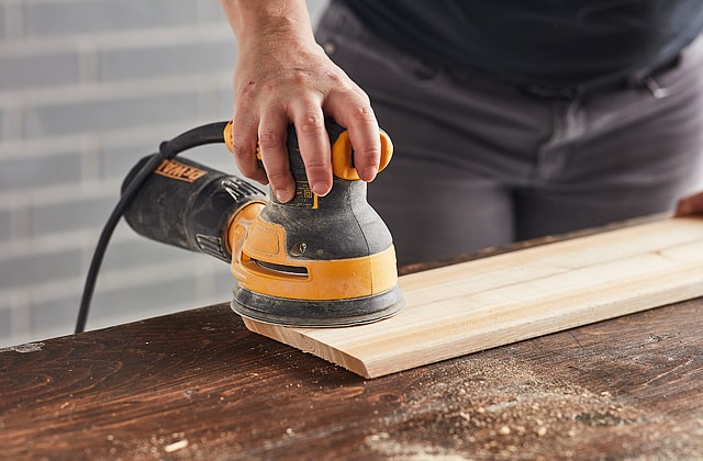 Person using an orbital sander