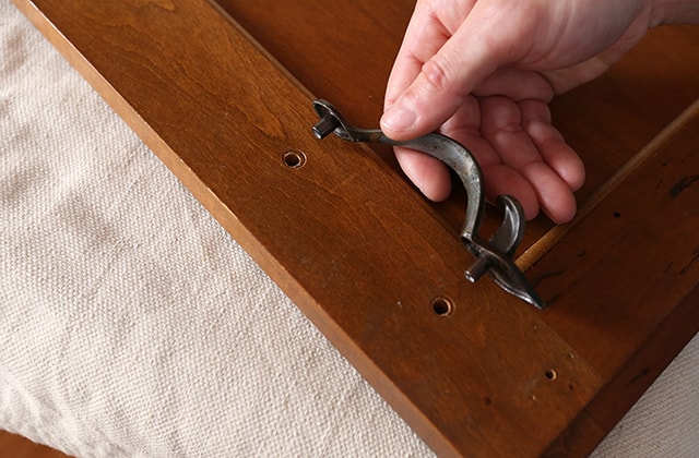 Person removing cabinet hardware