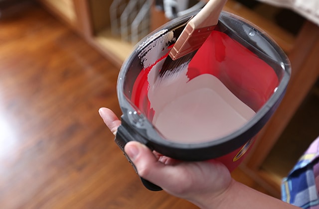 Small bucket filled with white paint