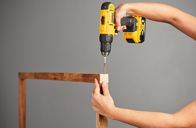 Person finishing a trellis frame