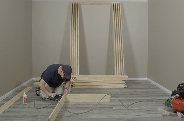 Person using a pneumatic nailer