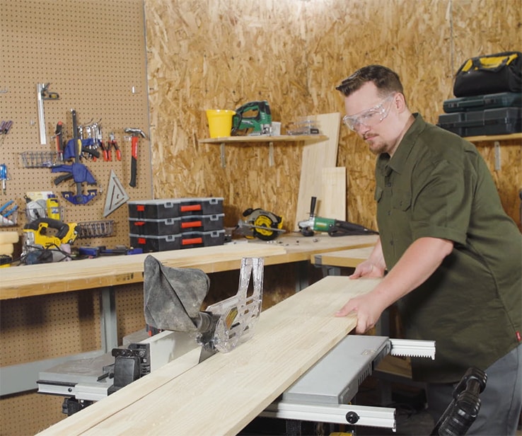 Man cutting wood slats with a table saw