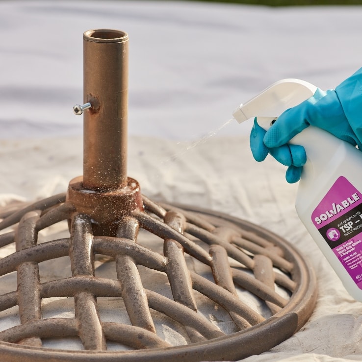 Person refinishing an umbrella stand