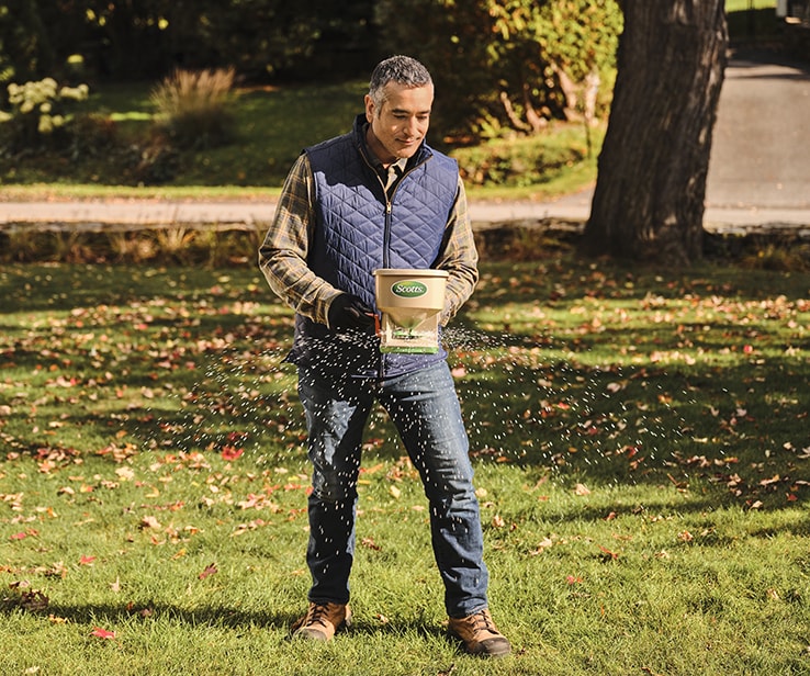 Person using a fertilizer spreader