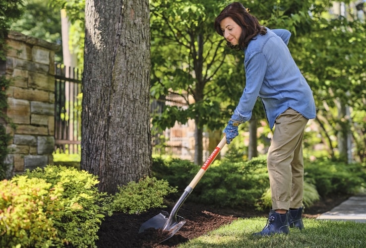 Woman maintaining a garden bed