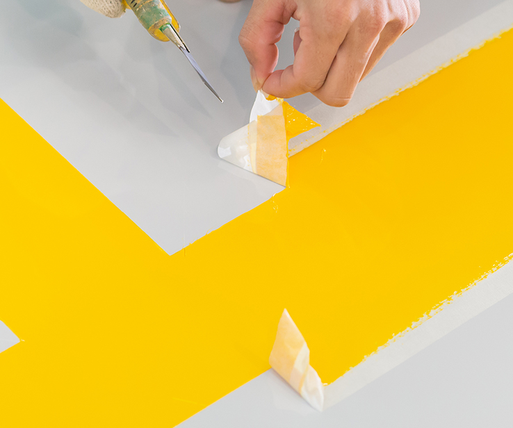 Person removing painter’s tape